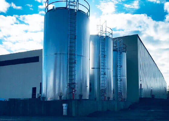 Three large food grade storage tanks at a client facility